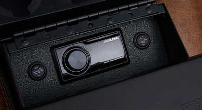 Black Alpine stereo system with seat heater buttons in center console of Classic Ford Bronco