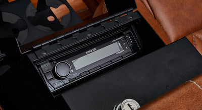 Kenwood stereo unit installed in black compartment of Classic Ford Bronco interior