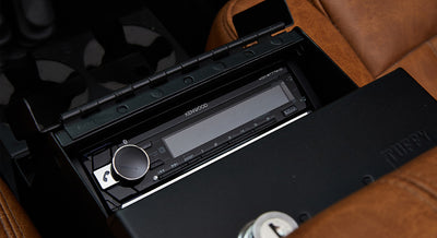Kenwood stereo unit inside a Classic Ford Bronco with tan leather seats