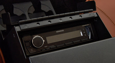 Kenwood stereo unit installed in center console with brown leather surroundings