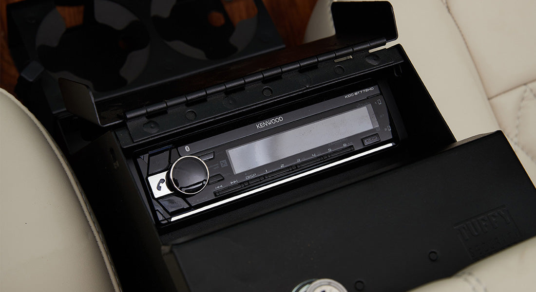 Classic Ford Bronco interior showing black Kenwood stereo unit inside a compartment
