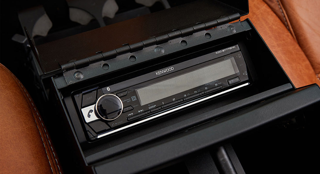 Kenwood stereo unit installed in caramel leather interior of Classic Ford Bronco