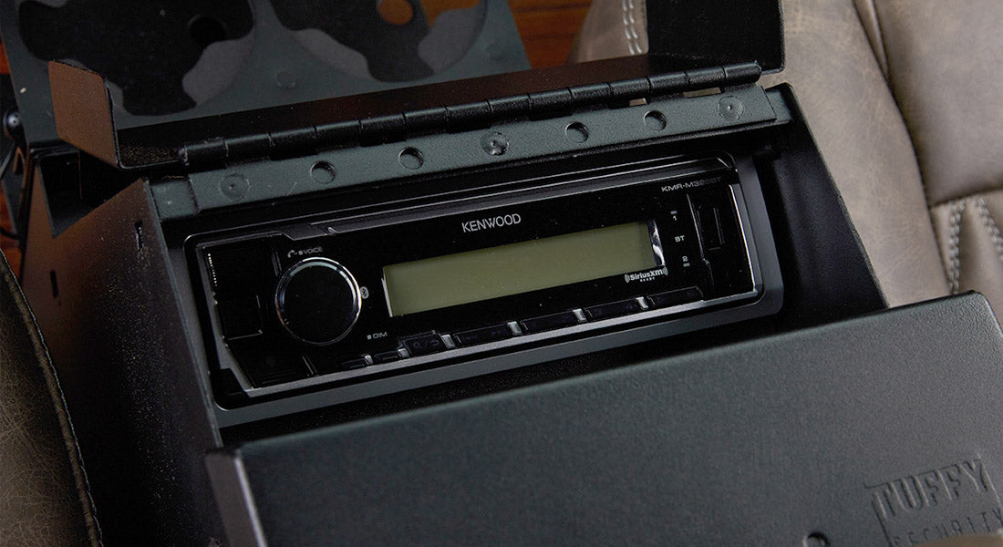 Black Kenwood stereo installed in the center console of a vehicle