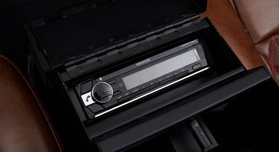 Kenwood stereo unit installed in center console of Classic Ford Bronco with brown leather interior