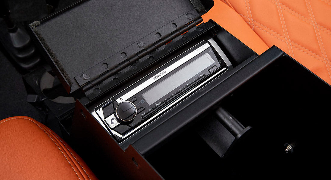 Kenwood stereo unit installed inside a black console in Classic Ford Bronco interior