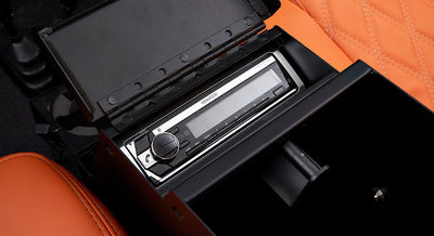 Kenwood stereo unit installed inside a black console in Classic Ford Bronco interior