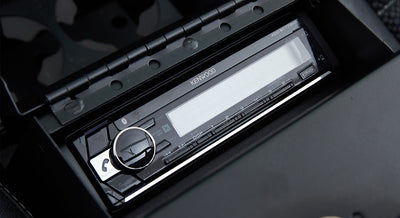 Kenwood stereo installed in Classic Ford Bronco center console with Bluetooth and audio controls