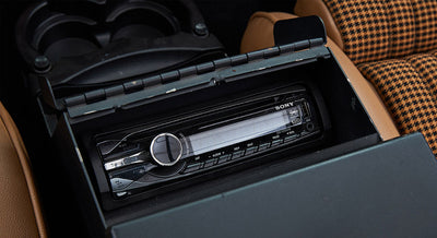 Classic Ford Bronco stereo head unit inside a brown console compartment