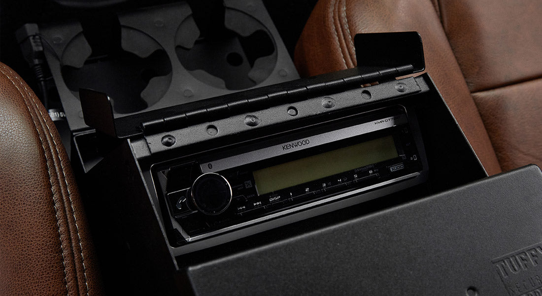 Kenwood stereo system installed in black console within Classic Ford Bronco interior
