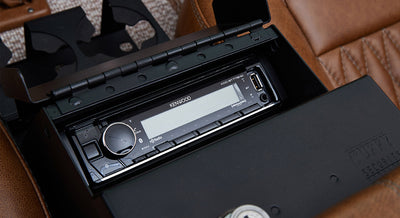 Kenwood stereo installed inside a black locking glovebox in Classic Ford Bronco