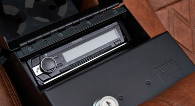 Kenwood stereo console installed with a locked black Tuffy security box nearby