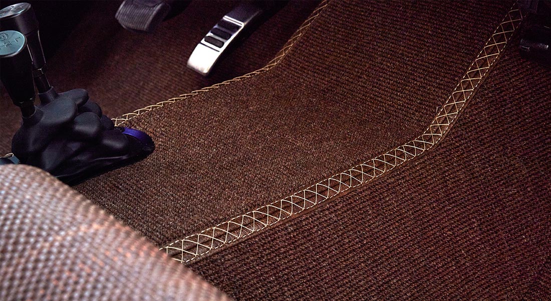 Brown floor carpet with visible detailed stitching inside Classic Ford Bronco