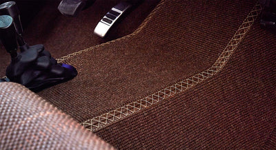 Brown floor carpet with visible detailed stitching inside Classic Ford Bronco