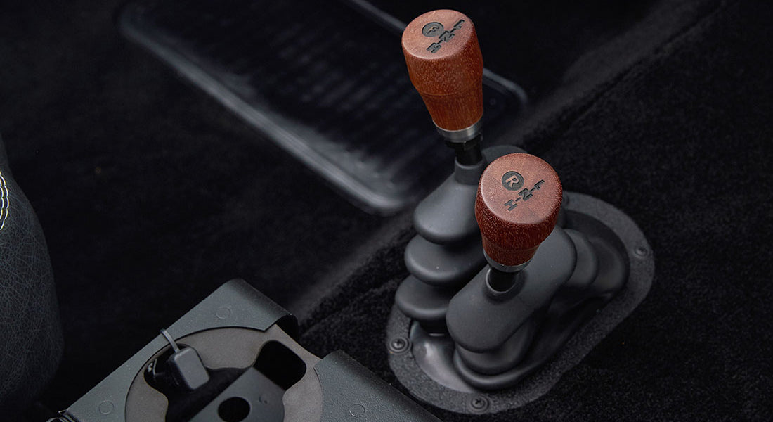 Two wooden gear shift knobs inside a Classic Ford Bronco cabin