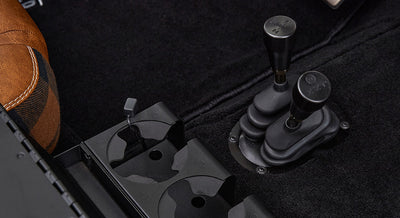 Gear and transfer case shifters next to cup holders in Classic Ford Bronco