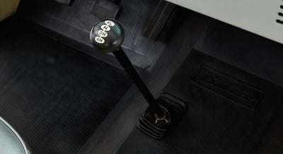 Close-up of Classic Ford Bronco transfer case lever with four-wheel drive settings on black knob.
