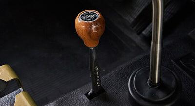 Close-up of wooden shift knob and two gear levers inside Classic Ford Bronco