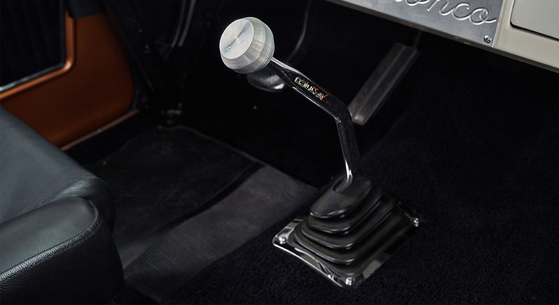 Interior floor view of Classic Ford Bronco showing gear shift lever with metal knob
