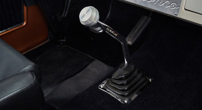 Interior floor view of Classic Ford Bronco showing gear shift lever with metal knob