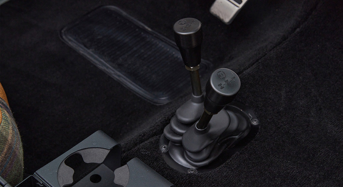 Shift levers for transmission and transfer case visible on floor inside Classic Ford Bronco