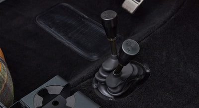 Shift levers for transmission and transfer case visible on floor inside Classic Ford Bronco