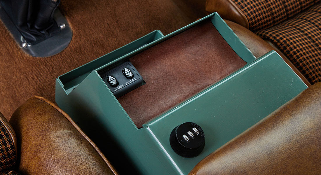 Green metal box with leather insert and cruise control buttons between Classic Ford Bronco seats