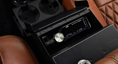 Center console of Classic Ford Bronco featuring a JVC audio system in black Tuffy security box