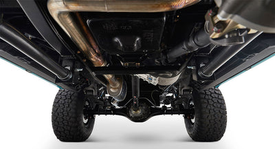 Undercarriage view showing suspension, tires, and exhaust system of a Classic Ford Bronco