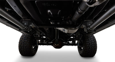 Undercarriage view showing vehicle axle, tires, and suspension components