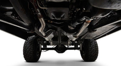 View of Classic Ford Bronco undercarriage showing frame, drive shaft, exhaust, and tires