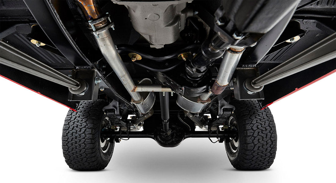 Undercarriage view showing suspension and exhaust system with large tires