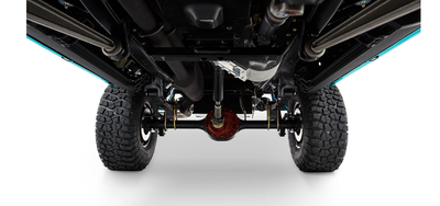 Undercarriage of Classic Ford Bronco showing suspension, drive shaft, axle and large off-road tires