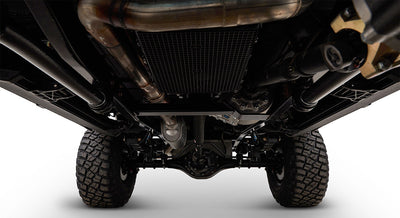 Underneath view of a vehicle showing suspension, exhaust, and tires