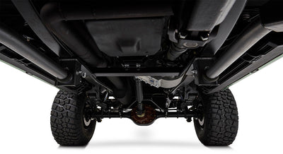 Undercarriage view showing suspension, axles, and exhaust of a Classic Ford Bronco with rugged tires