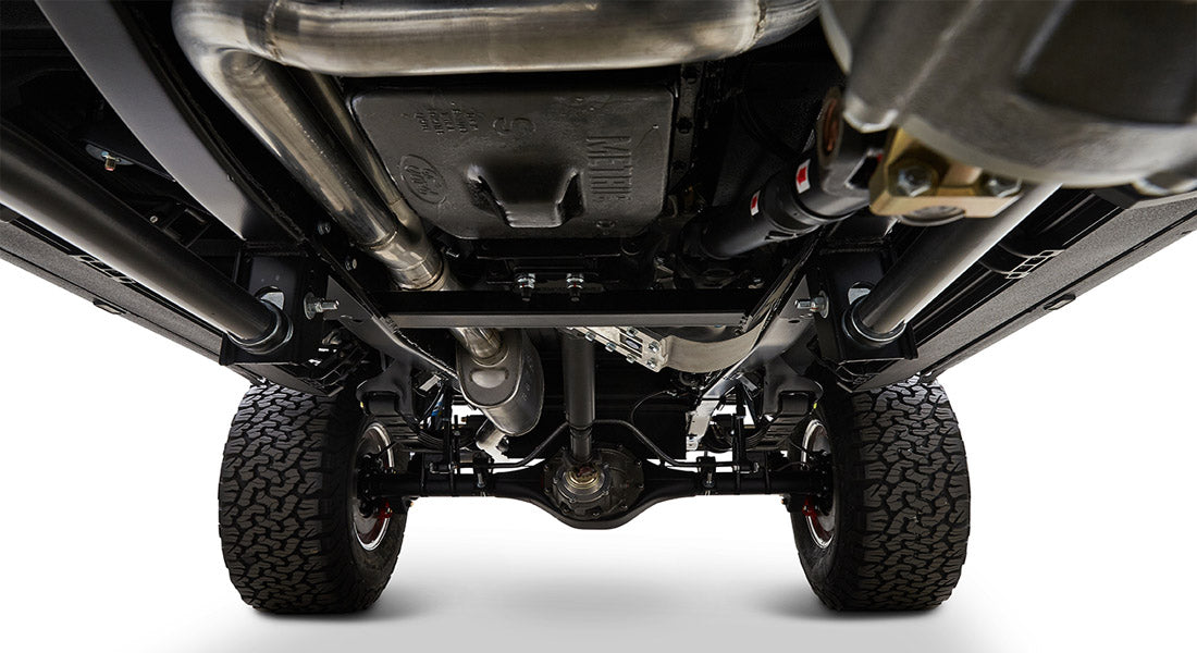 Undercarriage view of Classic Ford Bronco showing suspension, exhaust, and tires
