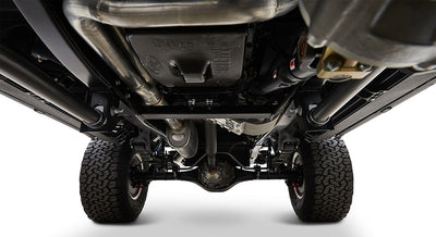 Undercarriage view of Classic Ford Bronco showing suspension, exhaust, and tires