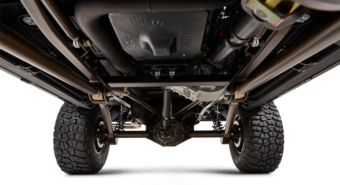 View of underside of Classic Ford Bronco showing suspension, exhaust, and drivetrain components
