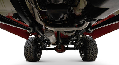 Undercarriage view of Classic Ford Bronco showing suspension, exhaust, and tires on white