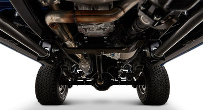 Undercarriage of Classic Ford Bronco showing exhaust system and rear axle with tires