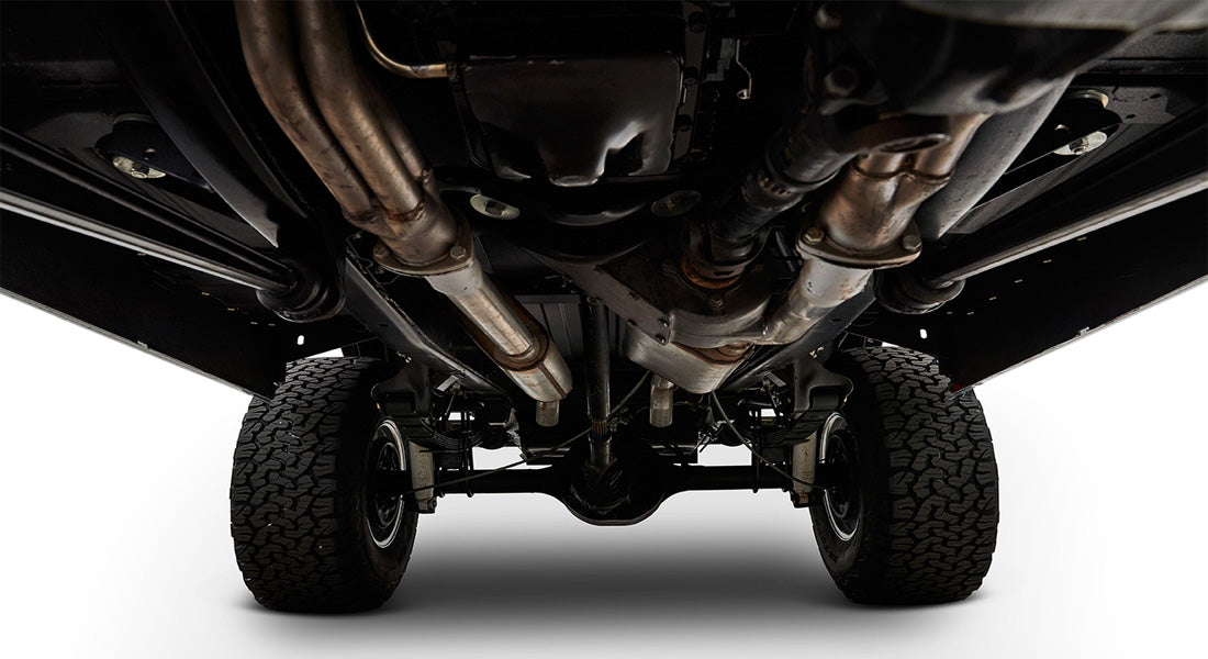 Undercarriage view with tires and exhaust system visible, showing chassis and suspension components