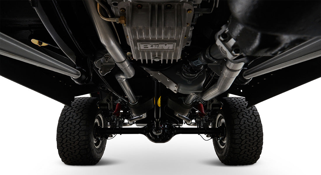 Underneath view of Classic Ford Bronco showing black restored undercarriage with exhaust and differential