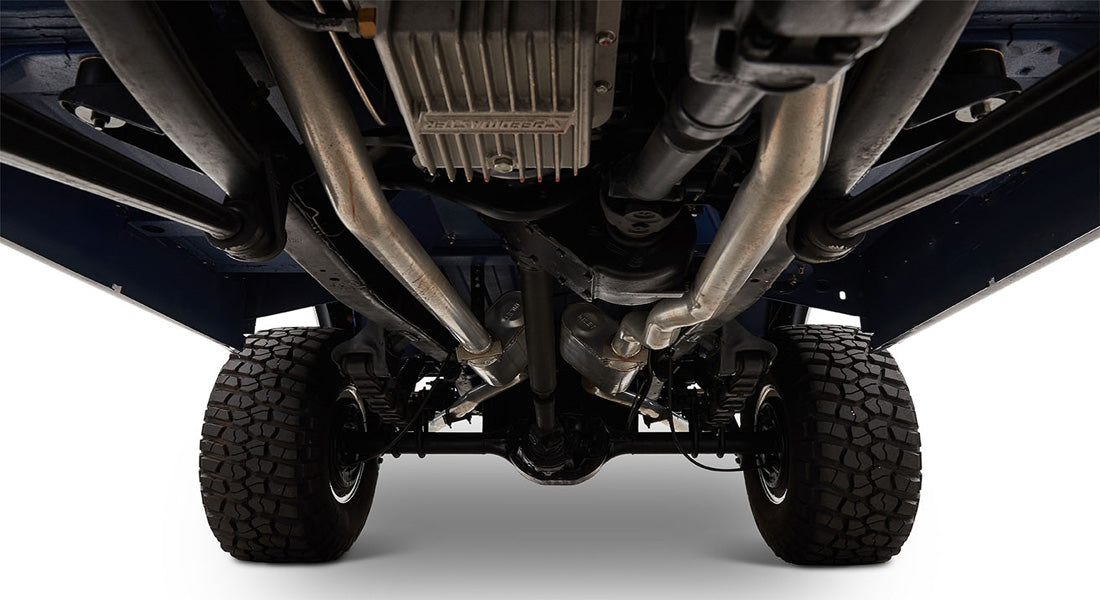 Detailed undercarriage of Classic Ford Bronco showing exhaust pipes, tires, and suspension components