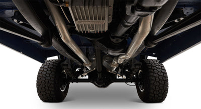 Detailed undercarriage of Classic Ford Bronco showing exhaust pipes, tires, and suspension components