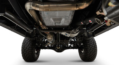 Undercarriage view showing exhaust system and off-road tires of a Classic Ford Bronco