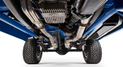 Undercarriage of Classic Ford Bronco with dual exhaust pipes and suspension components on white background