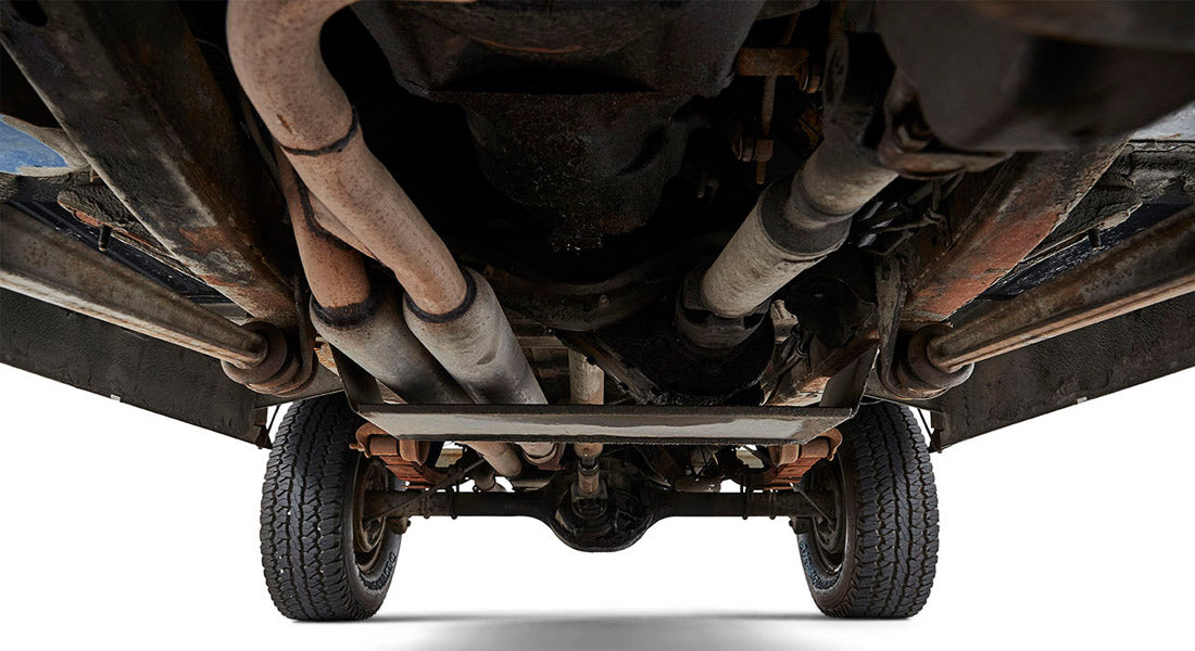 Undercarriage view showing tires, exhaust system and chassis parts of a Classic Ford Bronco
