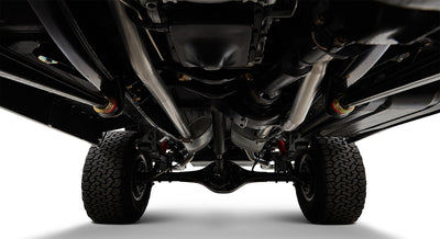 Undercarriage of Classic Ford Bronco showing suspension, exhaust system, and tires from below