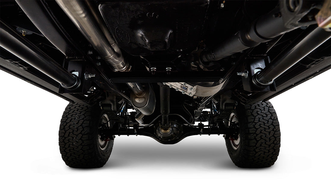 View of undercarriage showing suspension, axles, and tires of Classic Ford Bronco