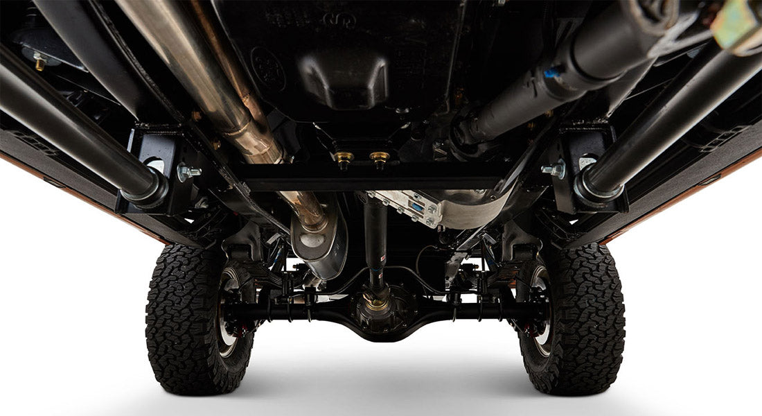 Close-up of Classic Ford Bronco's undercarriage with exhaust pipes and frame visible