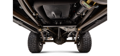 Undercarriage of Classic Ford Bronco showing suspension, axle, and wheels on white background